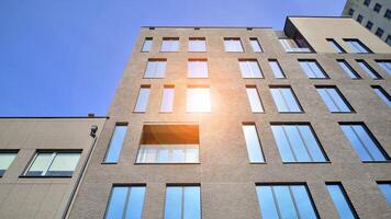 Modern office building detail. Perspective view of geometric angular concrete windows on the facade of a modernist brutalist style building. photo