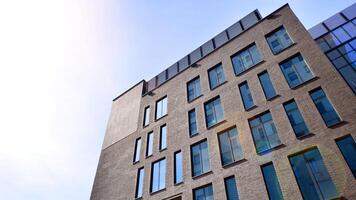 Modern office building detail. Perspective view of geometric angular concrete windows on the facade of a modernist brutalist style building. photo