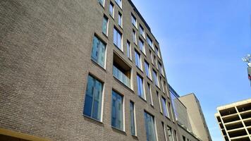 Modern office building detail. Perspective view of geometric angular concrete windows on the facade of a modernist brutalist style building. photo