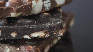 dark chocolate with mixed nut on black background video