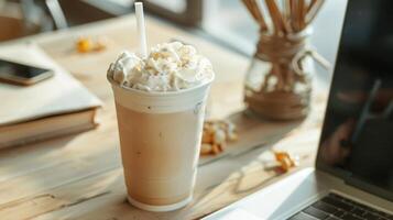 A frappe coffee on a work table in a boho-style office photo