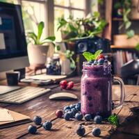 A fruit smoothie on a work table in a boho-style office photo