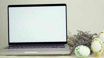 banner advertising postcard white laptop monitor screen next to lavender three embroidered painted eggs congratulations on easter place for text advertising sale time with family video