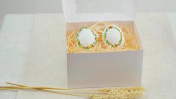 Easter embroidery on eggshell place banner postcard invitation congratulations three spikelets of wheat on white background box with transparent open top delivery chicken turkey goose egg 2 pieces video