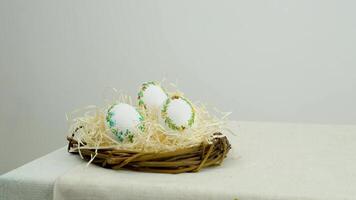 easter holiday banner side view of eggs in nest with lavender flowers ribbon embroidery on eggshell white eggs lie on straw on right space for text advertising ads postcard billboard easter holiday video