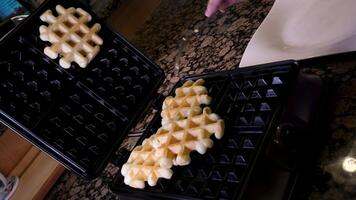 bake waffles Viennese Belgian waffles corrugated. The process of baking in an electric waffle iron. Cooking. video