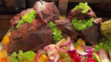 grilled ribs on plate with vegetables hidef slow motion intro Close-up of a cook turning a fork over barbecue pork charcoal Lamb Ribs and Vegetables on a Rotating Grill, meat and corn on a barbecue, video