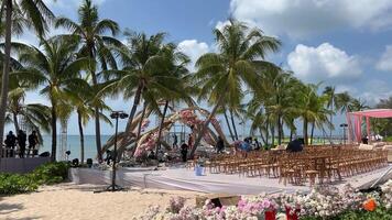 Wedding decor beach set up seaside floral roses arch sunny summer Germany. Best Wedding Western details Wood chairs gold concept. Setting stage festive marriage patterns tropical island sunset. video