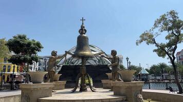 Vietnam phu quoc eiland groots wereld 18.03.2024sculptuur standbeeld van een groot klok in de centrum van de plein bronzen Mens rinkelen de klok Vietnam groots wereld phu quoc. sculpturen video