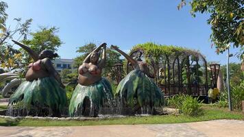 Vietnam Phu Quoc Island Grand World 03.18.2024 Sculpture waterfall three plump women dancing in skirts made of tropical plants crazy leather Vietnam Grand World Phu Quoc. Sculptures video