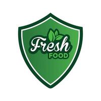 Fresh food typography logo design with green leaf shield vector