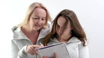 Mittel Zeitlupe von zärtlich Mutter und ihr wenig Tochter mit Nieder Syndrom Aufpassen Cartoons auf Laptop zusammen, ruhen auf Sofa im Leben Zimmer video