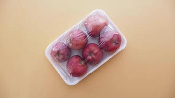apples wrapped in transparent plastic. video