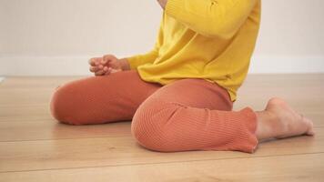 child sitting W posture on the floor . video