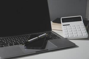 Flat lay, top view office table desk. Workspace with calculator,pen,laptop on white background.Copy Space for text,Empty Blank to word.Business Finance,Education Technology.Work from home. photo