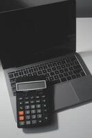 Flat lay, top view office table desk. Workspace with calculator,pen,laptop on white background.Copy Space for text,Empty Blank to word.Business Finance,Education Technology.Work from home. photo