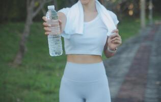 Young woman drinking protein shake outdoors photo