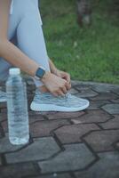 Young woman drinking protein shake outdoors photo