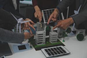 Business people having consultation about wind energy at company office. Business team discussing about windmill and alternative green energy. Executive meeting at modern office photo