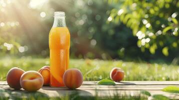 Packed peach juice on a background of green grass field photo