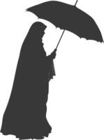 Silhouette independent emirates women wearing Abaya with umbrella black color only vector