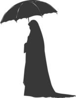 Silhouette independent emirates women wearing Abaya with umbrella black color only vector