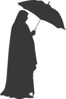 Silhouette independent emirates women wearing Abaya with umbrella black color only vector