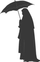 Silhouette independent emirates women wearing Abaya with umbrella black color only vector