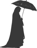 Silhouette independent emirates women wearing Abaya with umbrella black color only vector