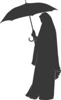 Silhouette independent emirates women wearing Abaya with umbrella black color only vector