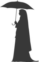 Silhouette independent emirates women wearing Abaya with umbrella black color only vector