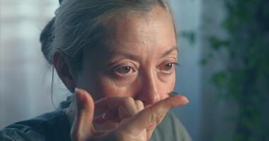 Woman putting on blue colored contact lenses video