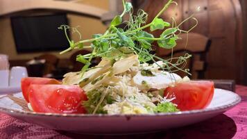 Caesar Salat mit Microgreens Lager Essen von Hähnchen Caesar Salat mit Croutons, Parmesan Käse und Microgreens serviert auf Weiß Teller im Mittelmeer Restaurant und gefilmt video