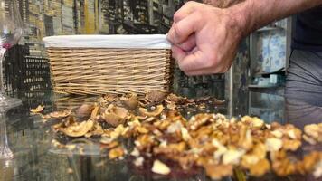 Male hands clean nuts with a nut cracker. Close-up. Walnut in shell video