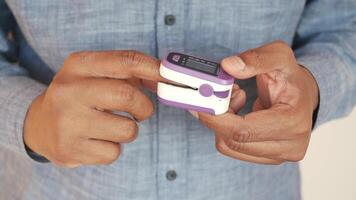 close up of man hand using pulse oximeter video