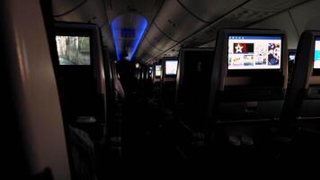 Passenger Viewing Flight Map on Airplane, Female passenger intently looking at a flight map on an airplane's screen during a flight, showing interest and engagement with her journey. video