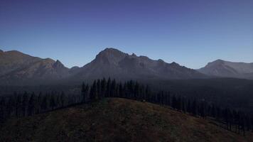 A view of a mountain range with trees and mountains in the background video