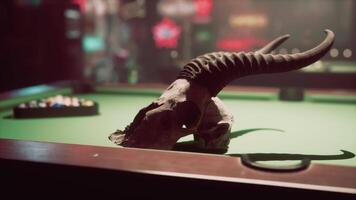 A fake animal skull on top of a pool table video