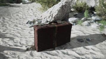A piece of luggage sitting on top of a sandy beach video