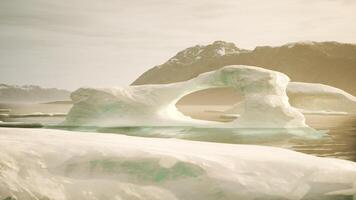 An iceberg floating in a body of water video