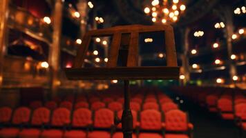 An empty theater with red seats and chandeliers video