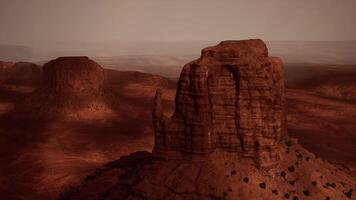 A rock formation in the middle of a desert video