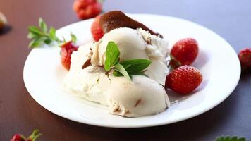 fresh organic cottage cheese with strawberries and ice cream in a plate on a wooden table video