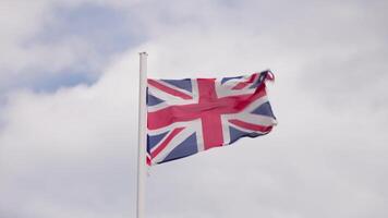 Flag fluttering in wind on cloudy day video