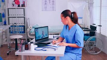 Assistant taking notes listening advice of remote doctor during call, virtual health conference, training webinar concept. Medical physician talking diagnoses patients, online meeting video