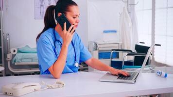 Medical nurse talking on mobile with doctor about list of patients and new appointments. Healthcare physician in medicine uniform, professional assistant helping with telehealth communication video