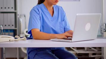 Portrait of professional medical nurse in blue practitioner uniform smiling at camera. Hospital healthcare worker, medicine clinical assistant health consultant therapist, telemedicine and healthcare support video