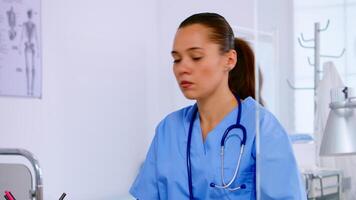 asistente médico hablando con paciente en teléfono desde hospital acerca de diagnóstico, haciendo equipo. cuidado de la salud médico en medicina uniforme, recepcionista médico Ayudar con telesalud comunicación video