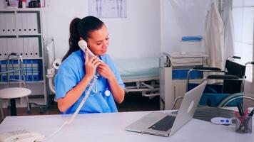 Physician nurse speaking at phone with patient analysing radiographics discussing the diagnosis, making appointment. Therapist, doctor assistant helping with telehealth communication, consultation video