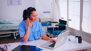 Healthcare physician prescribing prescriptions for patients during telehealth using headset, answering calls. Specialist health practitioner in medicine uniform, doctor nurse helping with appointment video